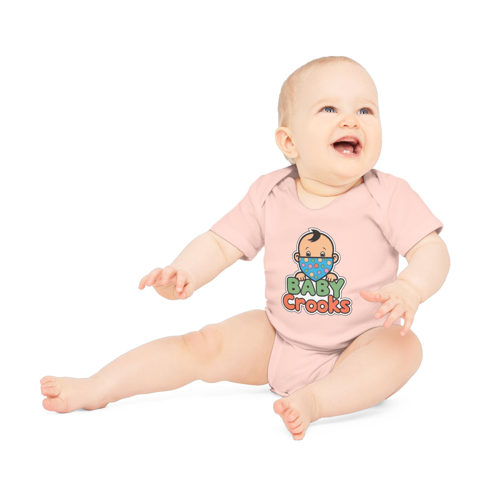 Baby wearing a pink onesie with 'Baby Crooks' print on a white background