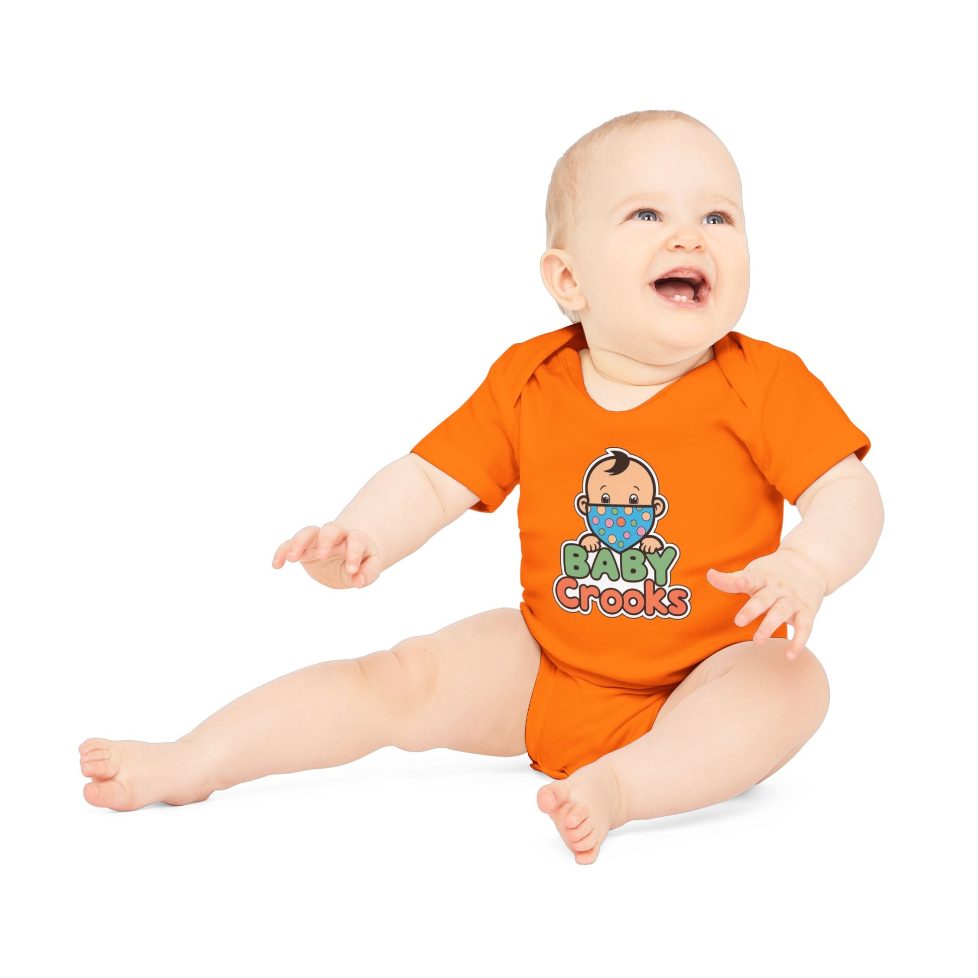 Baby wearing an orange onesie with 'Baby Crooks' print on a white background