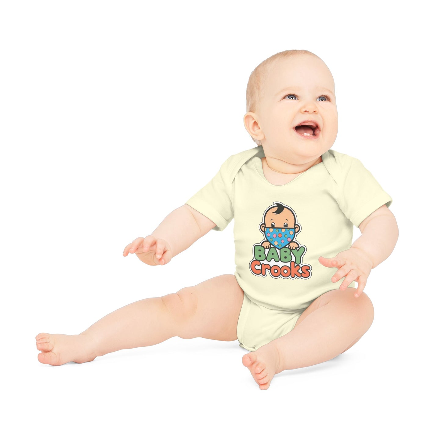 Baby wearing a yellow onesie with 'Baby Crooks' print on a white background